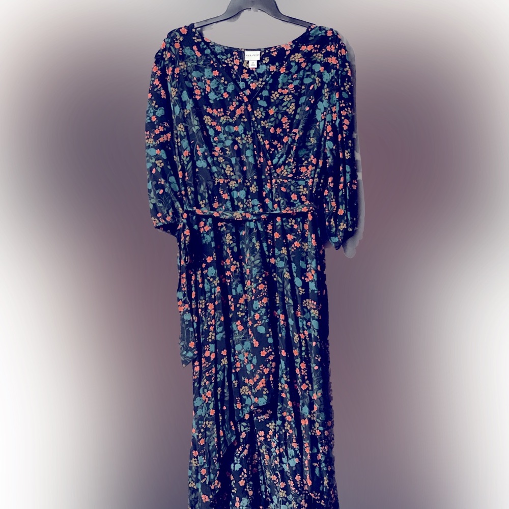 Beautiful floral dress. 3/4 length sleeves. Hem line is shorter in front.